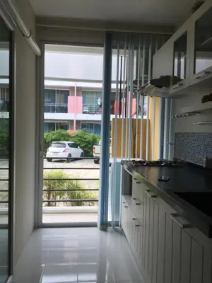 a kitchen with a view of a car in a parking lot at Best Point Condominium Cape Panwa in Phuket Town