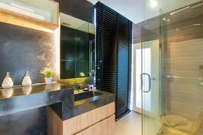 a bathroom with a sink and a glass shower at Icon Park Apartments - Kamala Beach in Kamala Beach