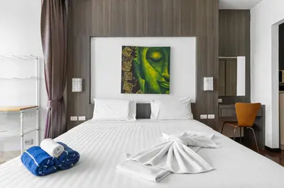 a bedroom with a bed with towels on it at Icon Park Apartments - Kamala Beach in Kamala Beach