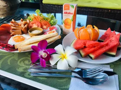 a table with two plates of food with fruit at The Thames Pool Access Resort & Villa - SHA Extra Plus in Chalong