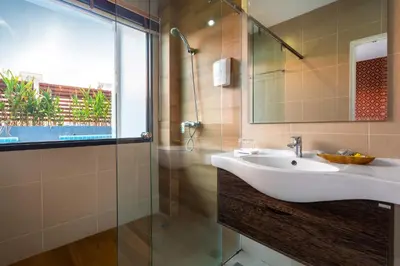 a bathroom with a sink and a shower at The Thames Pool Access Resort & Villa - SHA Extra Plus in Chalong
