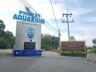 a sign for a planet aquarium on the side of a road at Spacious apartment with Ocean view in Panwa in Phuket Town