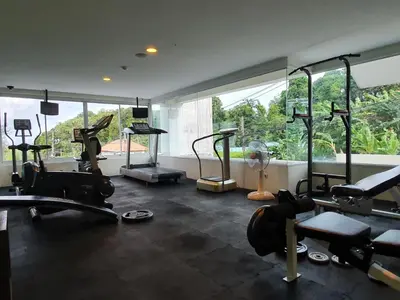 a gym with several tread machines in a room at Spacious apartment with Ocean view in Panwa in Phuket Town