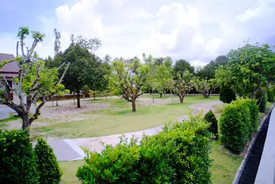 a view of a park with trees and bushes at Rnana Grand in Phangnga