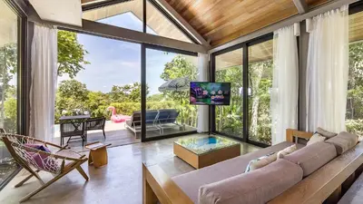 a living room with a couch and a tv at Island Escape Burasari in Phuket Town