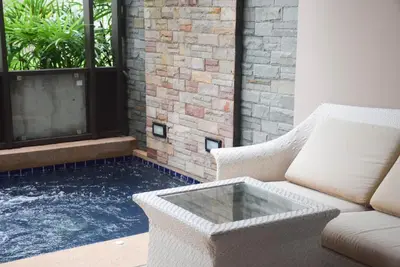 a living room with a couch and a window at Hotel COCO Phuket Bangtao Beach in Bang Tao Beach