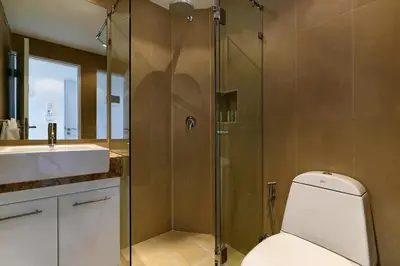 a bathroom with a shower with a toilet and a sink at Kata Ocean View condominium by Lofty in Kata Beach