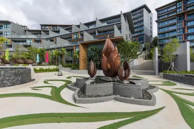 a statue in a courtyard in front of a building at Panora Condo by Villacarte in Surin Beach