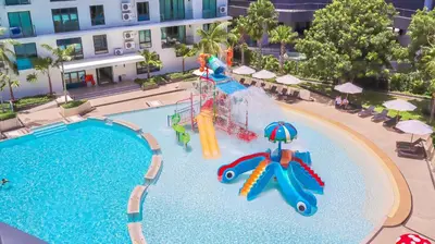 a pool with a water slide in a resort at Wyndham La Vita Rawai Phuket in Rawai Beach