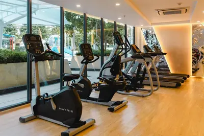 a gym with treadmills and ellipticals in a building at Wyndham La Vita Rawai Phuket in Rawai Beach