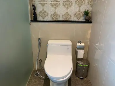 a bathroom with a white toilet in a room at Phuket View Coffee and Resort in Chalong