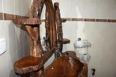 a wooden sink in a bathroom with a water fountain at Sanuk bungalows in Rawai Beach