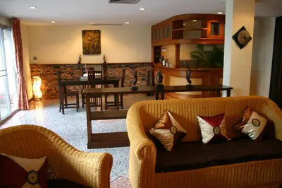 a living room with a couch and a dining room at Tolmaj Family Apartment in Ao Nang Beach