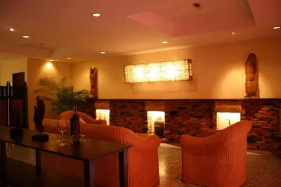a living room with a fireplace and a table and chairs at Tolmaj Family Apartment in Ao Nang Beach