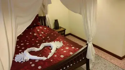 a bed with a heart shaped comforter on it at Tolmaj Family Apartment in Ao Nang Beach