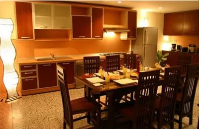 a kitchen with a table and chairs in a kitchen at Tolmaj Family Apartment in Ao Nang Beach