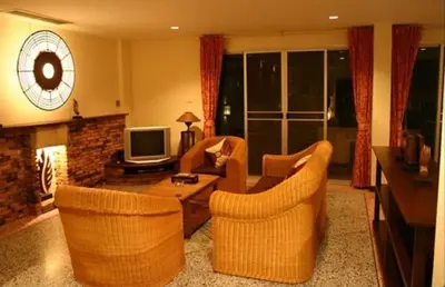 a living room with a couch and chairs and a tv at Tolmaj Family Apartment in Ao Nang Beach