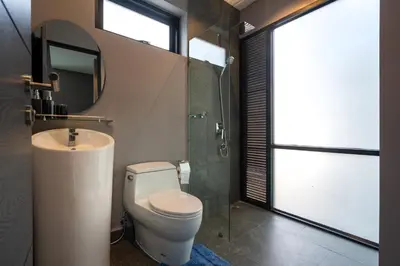 a bathroom with a toilet and a sink and a mirror at La Belle Pool Villa Phuket - Home Away from HOME in Bang Tao Beach