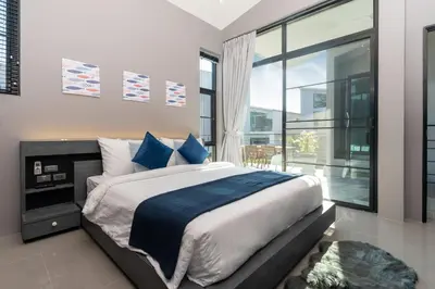 a bedroom with a large bed and a large window at La Belle Pool Villa Phuket - Home Away from HOME in Bang Tao Beach