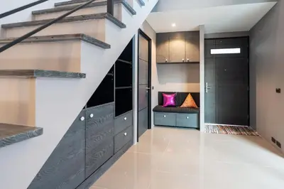 a staircase in a house with black and white at La Belle Pool Villa Phuket - Home Away from HOME in Bang Tao Beach