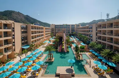 an aerial view of a resort with a pool and a water slide at Pamookkoo in Kata Beach