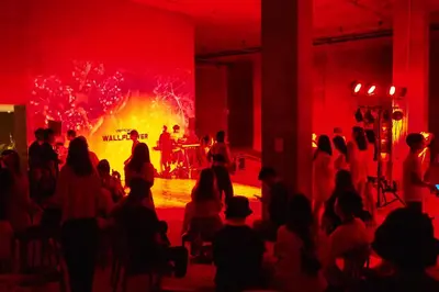 a crowd of people watching a show in a room with a fire at Pamookkoo in Kata Beach