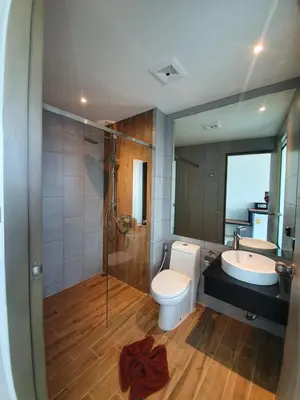a bathroom with a toilet and a sink and a shower at Atom Phuket Hotel in Nai Yang Beach