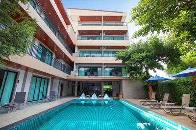 a swimming pool in front of a building at The Bell Airport Phuket Hotel - SHA Extra Plus in Nai Yang Beach