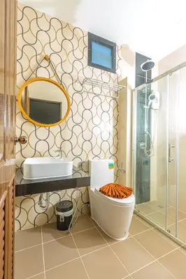 a bathroom with a toilet and a sink and a mirror at The Bell Airport Phuket Hotel - SHA Extra Plus in Nai Yang Beach