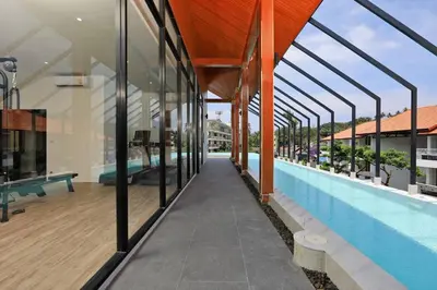 an external view of a building with a swimming pool at PALMYRAH SURIN, MODERN 1BR with Terrace, 150 meters to Surin Beach in Surin Beach