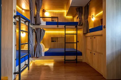 a room with two bunk beds and a hallway at Patong Poshtel in Patong Beach