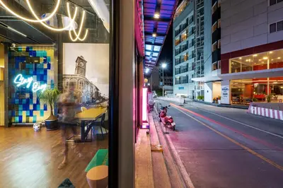 a view from a window of a city street at night at Patong Poshtel in Patong Beach
