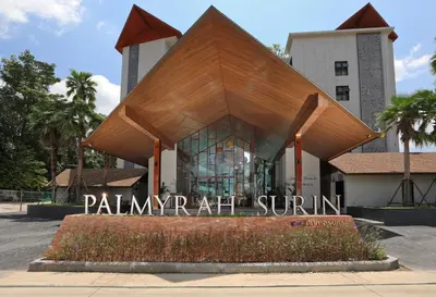 a building with a sign in front of it at The Sea View room in Palmyrah Surin by Holy Cow in Surin Beach