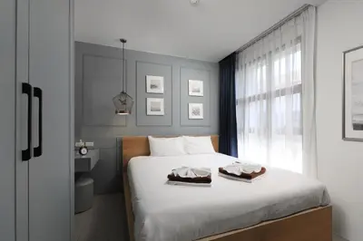 a bedroom with a bed with two towels on it at The Sea View room in Palmyrah Surin by Holy Cow in Surin Beach
