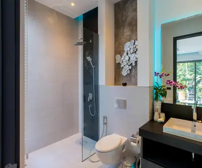 a bathroom with a shower and a toilet and a sink at Villa Omari 5Bedroom with Pool near Kata Beach in Kata Beach