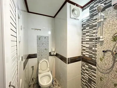 a bathroom with a toilet and a shower at Bangtao Rooms in Bang Tao Beach