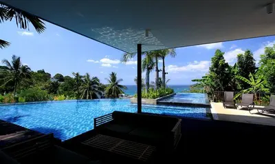 a large swimming pool with a view of the ocean at The heights B18 Seaview near Kata Beach in Kata Beach