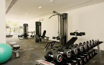 a gym with a row of tread machines and weights at The heights B18 Seaview near Kata Beach in Kata Beach