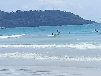a group of people on surfboards in the ocean at The heights B18 Seaview near Kata Beach in Kata Beach