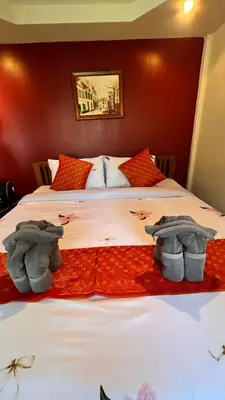 a bedroom with two beds with towels on them at At Thara Aonang in Ao Nang Beach