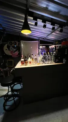 a bar with bottles of alcohol on a counter at At Thara Aonang in Ao Nang Beach