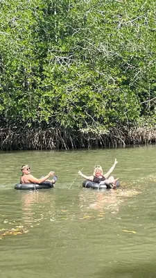 two people are in the water on rafts at At Thara Aonang in Ao Nang Beach