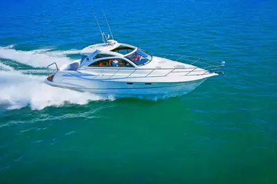 a white boat on the water in the ocean at Kana Triple L Hotel Phuket\u666e\u5409\u5c9b\u5361\u5a1c3L\u9152\u5e97 in Patong Beach