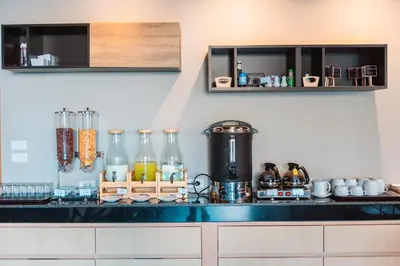a kitchen with a counter top with many bottles at Kana Triple L Hotel Phuket\u666e\u5409\u5c9b\u5361\u5a1c3L\u9152\u5e97 in Patong Beach