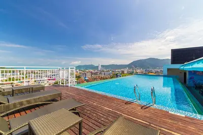 a swimming pool on the roof of a building at Kana Triple L Hotel Phuket\u666e\u5409\u5c9b\u5361\u5a1c3L\u9152\u5e97 in Patong Beach