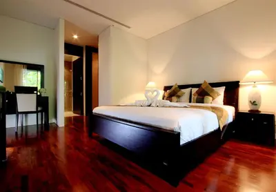 a bedroom with a large bed with two lamps on it at Kata Gardens Luxury Apartment 8A at Kata Noi Beach in Kata Beach