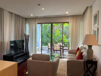 a living room with a couch and chairs and a television at Kata Gardens Luxury Apartment 8A at Kata Noi Beach in Kata Beach
