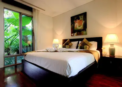 a bedroom with a large bed and a large window at Kata Gardens Luxury Apartment 8A at Kata Noi Beach in Kata Beach
