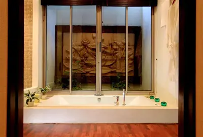 a bath tub in a room with a window at Kata Gardens Luxury Apartment 8A at Kata Noi Beach in Kata Beach