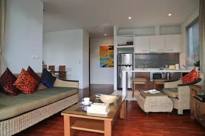 a living room with a couch and a table at Kata gardens luxury 2bedroom 4B Near Kata Noi Beach in Kata Beach